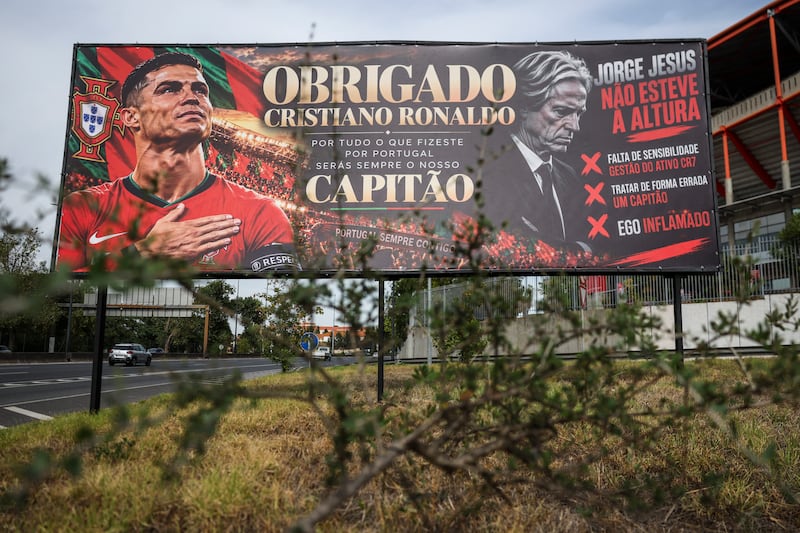 A billboard in Lisbon reading 'Thank you Cristiano Ronaldo for all that you did for Portugal, you will be always our captain' mixed with a message critical of Jorge Jesus reading 'Jorge Jesus was not up to the job' and 'lack of sensitivity in managing the CR7 asset'. Photograph: Patricia De Melo Moreira/AFP via Getty Images