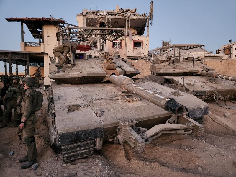 Tanks and ruined buildings seen by the group of journalists permitted to enter the strip by the Israeli military. Photograph: Ronen Bergman/The New York Times
                      