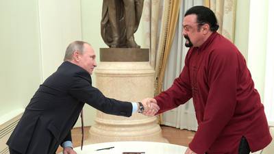 Vladimir Putin presents Steven Seagal with Russian passport