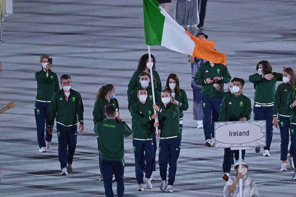 Brendan Irvine and Kellie Harrington carry Irish flag at opening ceremony