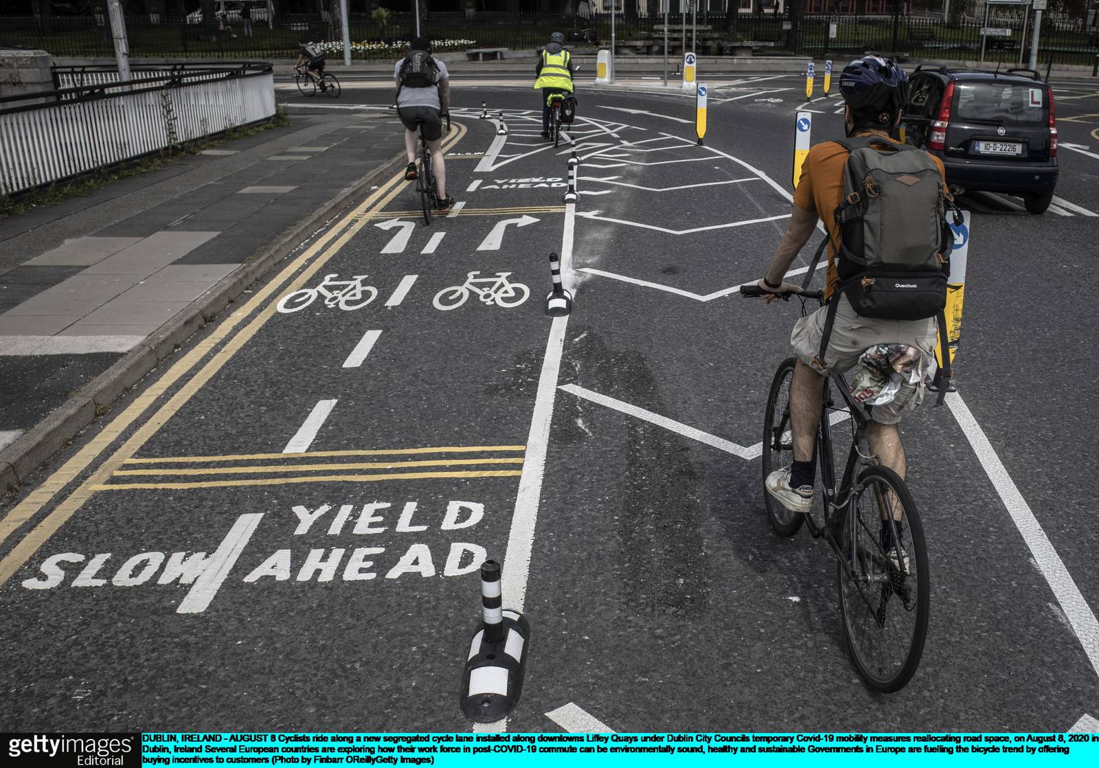 DUBLIN, IRELAND - AUGUST 8: Cyclists ride along a new segregated cycle lane installed along downtown's Liffey Quays under Dublin City Council's temporary Covid-19 mobility measures reallocating road space, on August 8, 2020 in Dublin, Ireland. Several European countries are exploring how their work force in post-COVID-19 commute can be environmentally sound, healthy and sustainable. Governments in Europe are fuelling the bicycle trend by offering buying incentives to customers. (Photo by Finbarr O'Reilly/Getty Images)