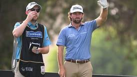 Cameron Young leads the way in Dubai with Dubliner Paul McBride on the bag