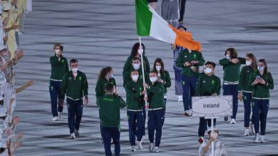 Brendan Irvine and Kellie Harrington carry Irish flag at opening ceremony