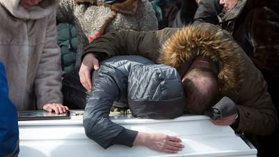 Anger mounts on day funerals begin of Russia blaze victims