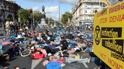 Extinction Rebellion stage ‘die in’ protest on O’Connell Bridge