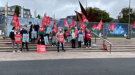 Community organisation workers take part in work stoppages over pay