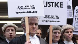Trials grind to halt as barristers go on first strike in 500 years over fee cut